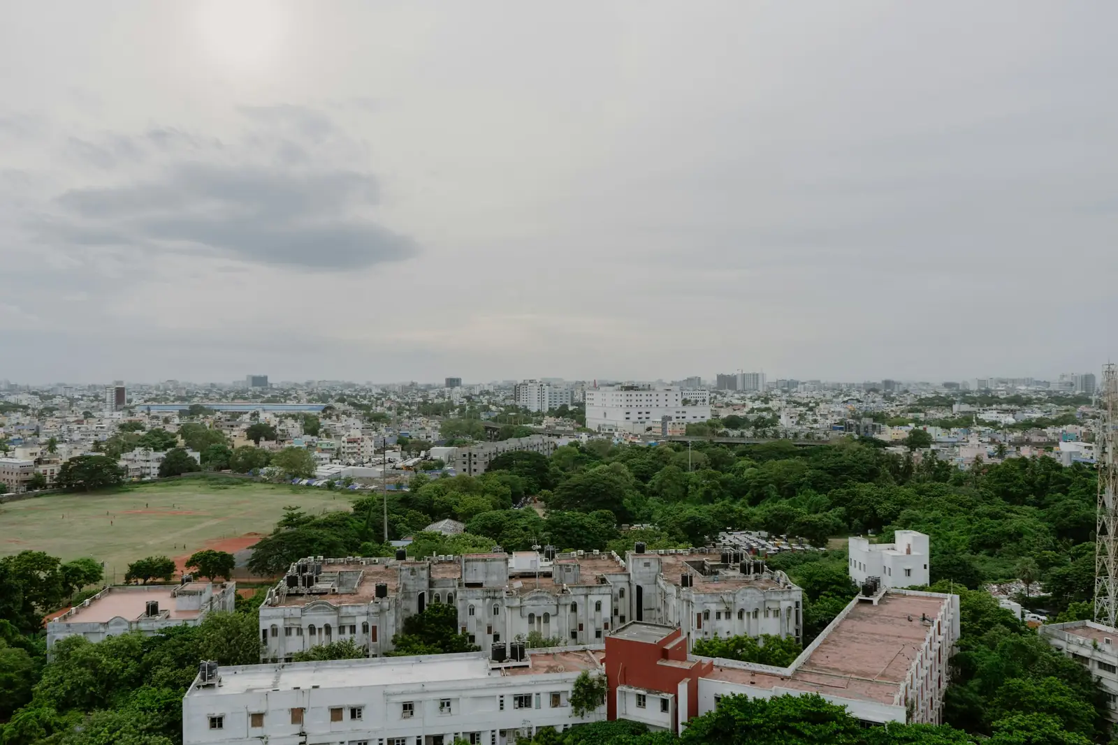 Aerial view of Chennai's rooftops and green canopy stretching to the Bay of Bengal